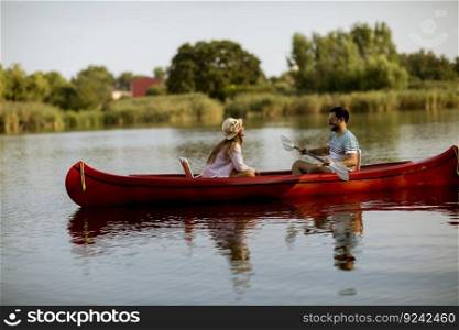 Loving couple rowing on the lake at summer day