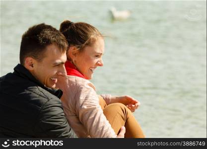 loving couple spending leisure time together at beach hugging side view