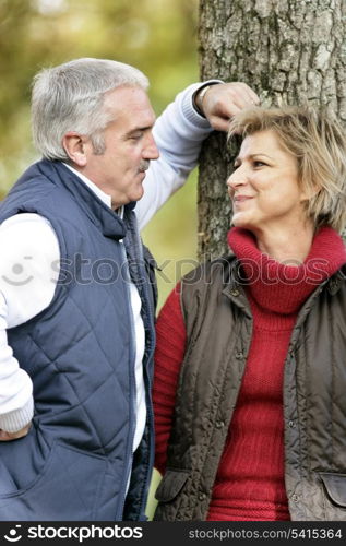 Loving couple standing by a tree