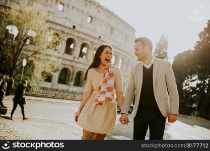 Loving couple visiting Italian famous landmarks Colosseum in Rome, Italy
