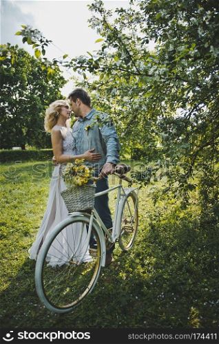 Loving couple with a bicycle.. Walk of the girl and the guy with a bicycle 3123.