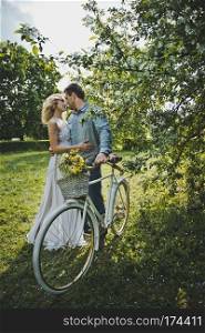 Loving couple with a bicycle.. Walk of the girl and the guy with a bicycle 3123.