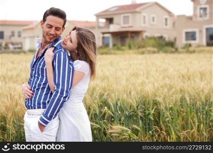 Loving couple, woman hugging her boyfriend in the park