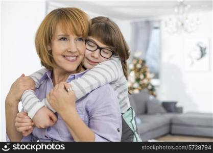 Loving daughter embracing mother at home