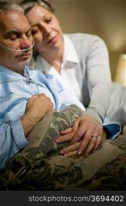 Loving elderly couple sleeping in bed sick husband