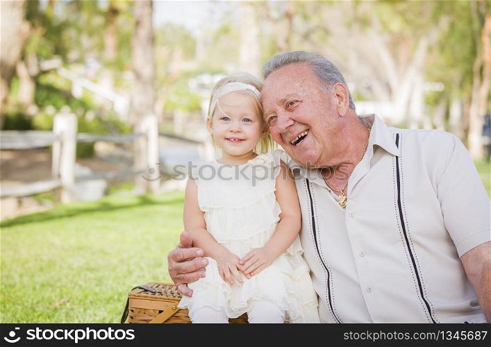 Loving Grandfather and Granddaughter Hugging Outside At The Park.