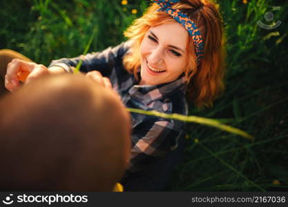 Loving hipster couple walking in the field, kissing and holding hands, hugging, lying in the grass in the summer at sunset. valentines day.. Loving hipster couple walking in the field, kissing and holding hands, hugging, lying in the grass in the summer at sunset. valentines day