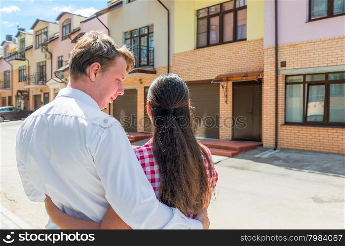 loving married couple looking at their new home