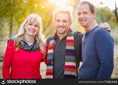 Loving Middle Aged Parents and Young Son Portrait Outdoors.
