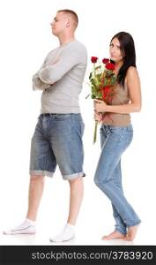 Loving Portrait of beautiful young happy smiling couple isolated - man down on his knee giving his girlfriend a rose and the girl isolated on white