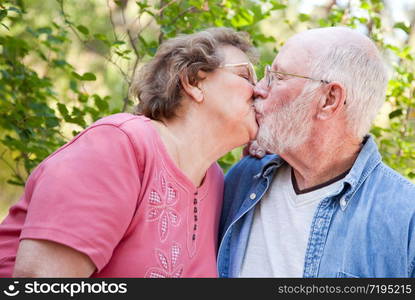 Loving Senior Couple Kissing and Enjoying the Outdoors Together.