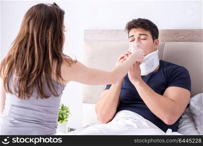 Loving wife taking care of injured husband in bed