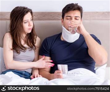 Loving wife taking care of injured husband in bed. The loving wife taking care of injured husband in bed