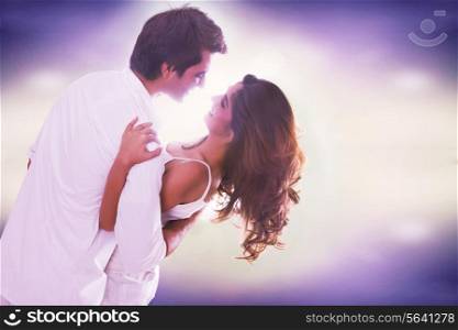 Loving young couple dancing over colored background