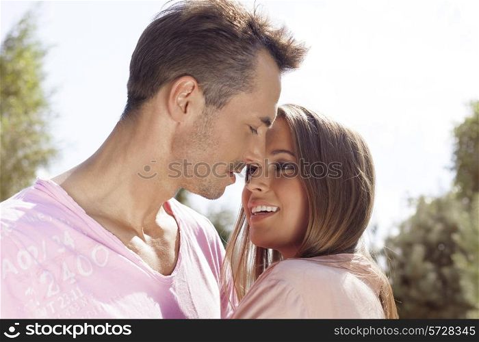 Loving young couple embracing in park