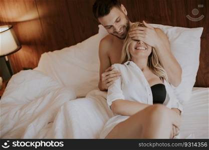 Loving young couple having fun in the bed