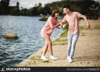 Loving young couple kissing and hugging in outdoors. Love and tenderness, dating, romance, family,. Loving young couple kissing and hugging in outdoors. Love and tenderness, dating, romance, family, anniversary concept.