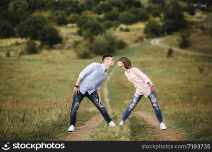 Loving young couple kissing and hugging in outdoors. Love and tenderness, dating, romance, family,. Loving young couple kissing and hugging in outdoors. Love and tenderness, dating, romance, family, anniversary concept.