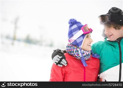 Loving young couple looking at each other in snow