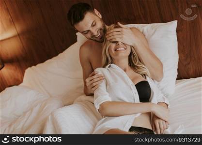 Loving young couple lying in the bed