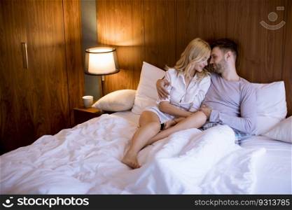 Loving young couple on the bed in the bedroom