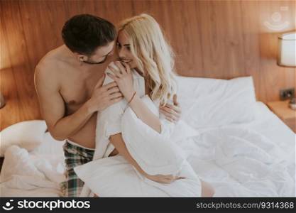 Loving young couple on the bed in the bedroom