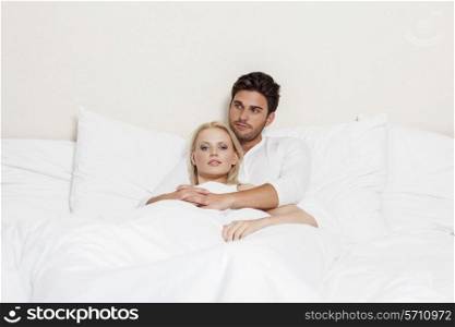 Loving young couple relaxing in bed