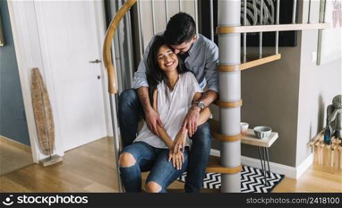 loving young couple sitting spiral staircase