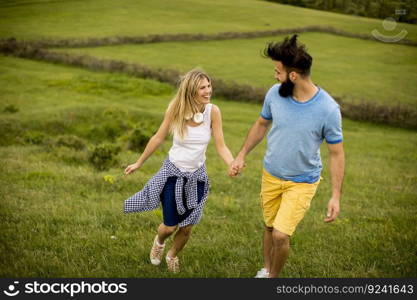 Lovinh couple enjoying a walk through grass land