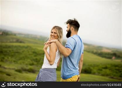 Lovinh couple enjoying a walk through grass land