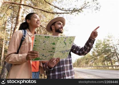 low angle couple traveling with map