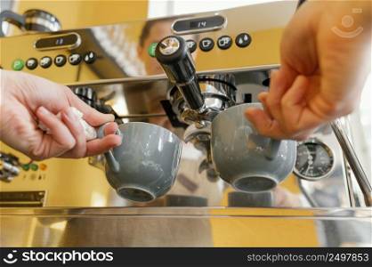 low angle female barista using coffee machine