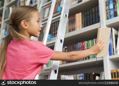 low angle girl placing book shelf