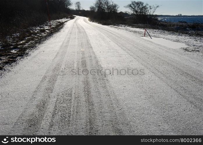 Low angle image of a backlit and wintry country road