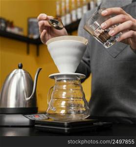 low angle male barista putting coffee filter