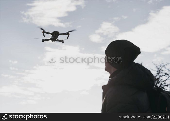 low angle man watching drone