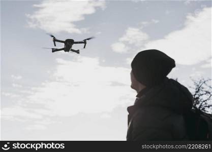low angle man watching drone
