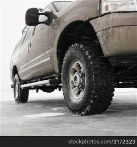 Low angle of four wheel drive truck on frozen lake in Green Lake, Minnesota, USA.