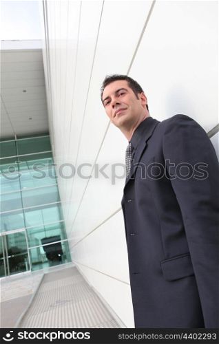 Low angle shot of a businessman outside an office block