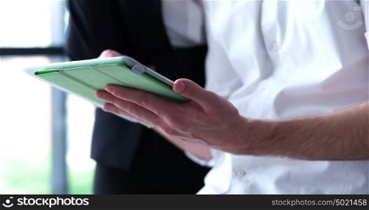 low angle shot of Businessman And Woman Using Digital Tablet
