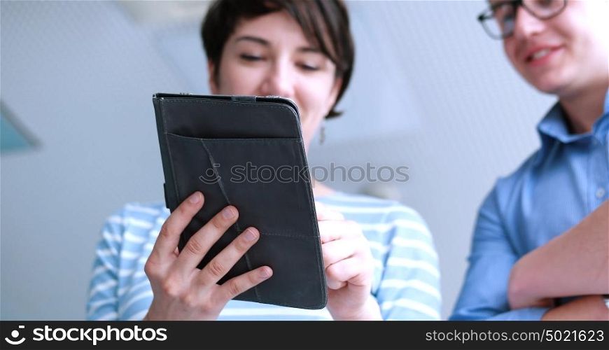 low angle shot of Businessman And Woman Using Digital Tablet