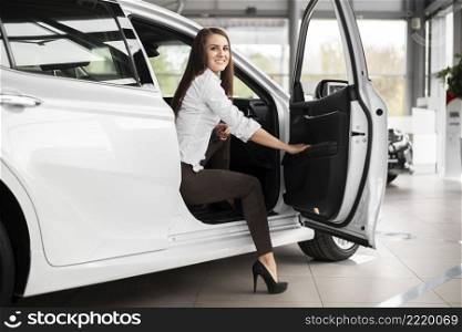 low angle smiley woman stepping out car