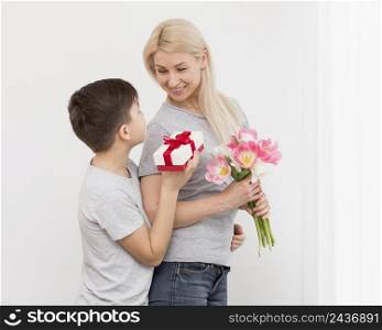 low angle son offering gift mother