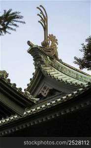 low angle traditional japanese wooden temple roof details
