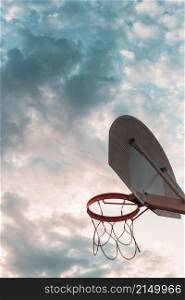 low angle view basketball hoop against cloudy sky