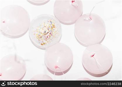 low angle view birthday balloons with streamers white backdrop