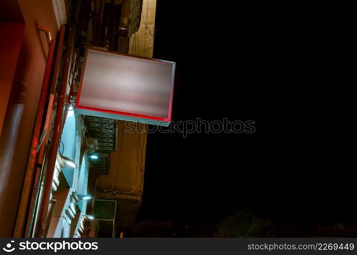 low angle view illuminated billboard residential building against sky