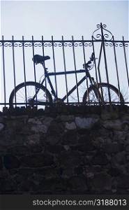 Low angle view of a bicycle leaning against a railing