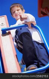 Low angle view of a boy standing and pointing