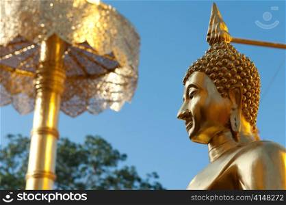 Low angle view of a Buddha statue at Wat Phrathat Doi Suthep, Chiang Mai, Thailand